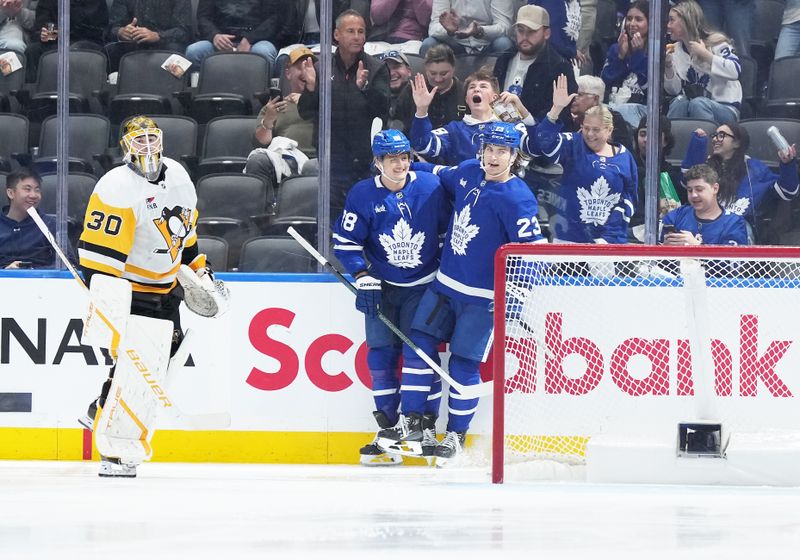 Oct 12, 2024; Toronto, Ontario, CAN; Toronto Maple Leafs right wing William Nylander (88) scores a goal and celebrates with left wing Matthew Knies (23) against the Pittsburgh Penguins during the second period at Scotiabank Arena. Mandatory Credit: Nick Turchiaro-Imagn Images