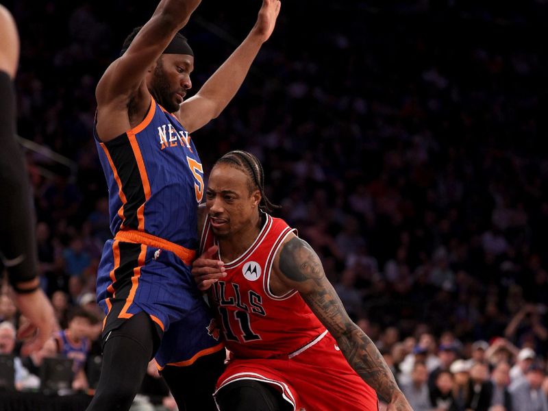 NEW YORK, NEW YORK - APRIL 14:  DeMar DeRozan #11 of the Chicago Bulls heads for the net as Precious Achiuwa #5 of the New York Knicks defends at Madison Square Garden on April 14, 2024 in New York City. The New York Knicks defeated the Chicago Bulls 120-119 in OT. NOTE TO USER: User expressly acknowledges and agrees that, by downloading and or using this photograph, User is consenting to the terms and conditions of the Getty Images License Agreement. (Photo by Elsa/Getty Images)