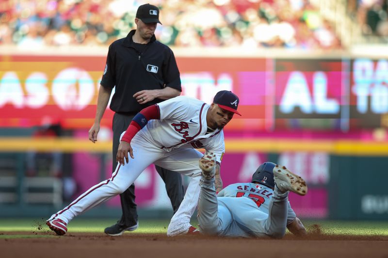 May 30, 2024; Atlanta, Georgia, USA; Atlanta Braves shortstop Orlando Arcia (11) tags out Washington Nationals third baseman Nick Senzel (13) on a steal attempt in the second inning at Truist Park. Mandatory Credit: Brett Davis-USA TODAY Sports