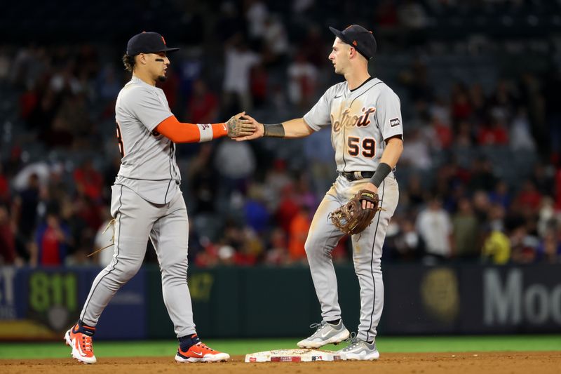 Sep 16, 2023; Anaheim, California, USA;  Detroit Tigers shortstop Javier Baez (28) and second baseman Zack Short (59) celebrate a victory after defeating the Los Angeles Angels 5-4 at Angel Stadium. Mandatory Credit: Kiyoshi Mio-USA TODAY Sports