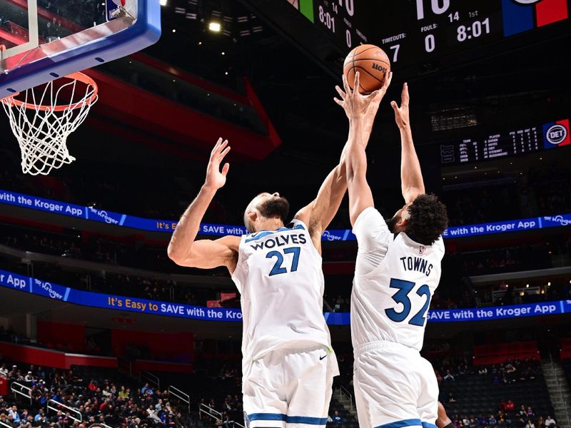 DETROIT, MI - JANUARY 17: Rudy Gobert #27 and Karl-Anthony Towns #32 of the Minnesota Timberwolves reach for a rebound during the game against the Detroit Pistons on January 17, 2024 at Little Caesars Arena in Detroit, Michigan. NOTE TO USER: User expressly acknowledges and agrees that, by downloading and/or using this photograph, User is consenting to the terms and conditions of the Getty Images License Agreement. Mandatory Copyright Notice: Copyright 2024 NBAE (Photo by Chris Schwegler/NBAE via Getty Images)