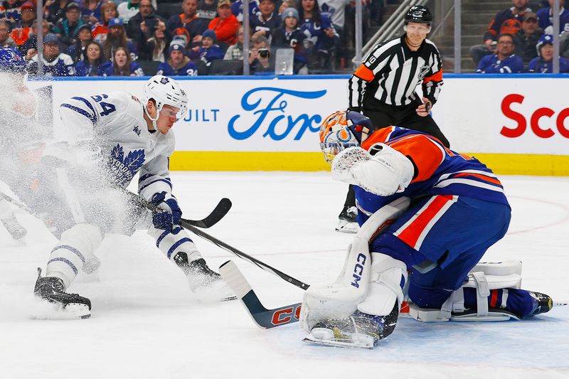 Jan 16, 2024; Edmonton, Alberta, CAN; Edmonton Oilers goaltender Stuart Skinner (74) makes a save on  on Toronto Maple Leafs forward David Kampf (64) during the second period at Rogers Place. Mandatory Credit: Perry Nelson-USA TODAY Sports