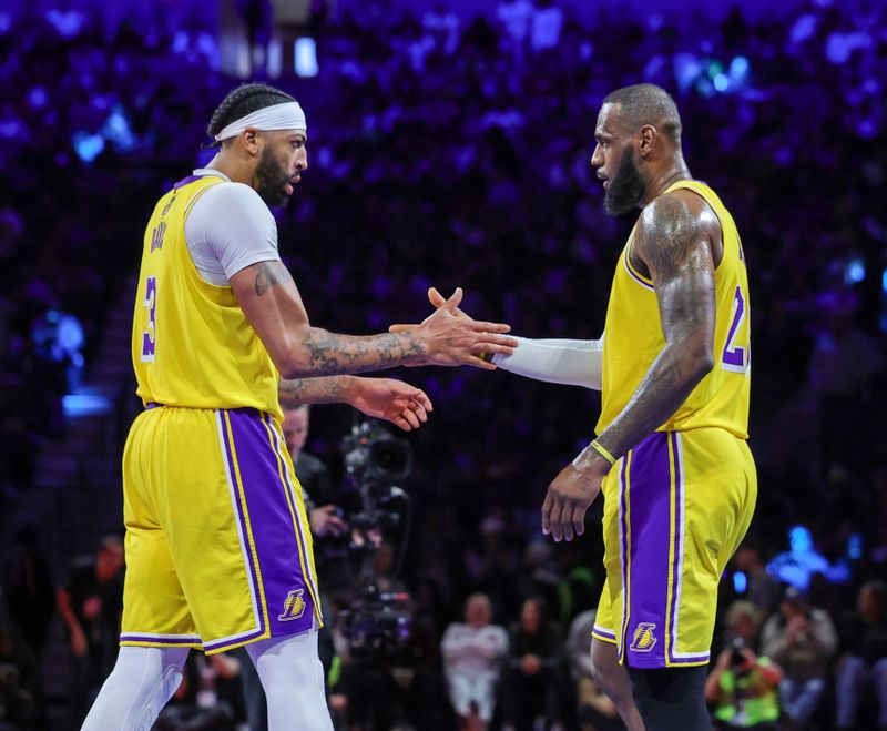 LAS VEGAS, NEVADA - DECEMBER 07: Anthony Davis #3 and LeBron James #23 of the Los Angeles Lakers slap hands after Davis scored against the New Orleans Pelicans off an alley-oop pass from James in the second half of the West semifinal game of the inaugural NBA In-Season Tournament at T-Mobile Arena on December 07, 2023 in Las Vegas, Nevada. The Lakers defeated the Pelicans 133-89. NOTE TO USER: User expressly acknowledges and agrees that, by downloading and or using this photograph, User is consenting to the terms and conditions of the Getty Images License Agreement.  (Photo by Ethan Miller/Getty Images)