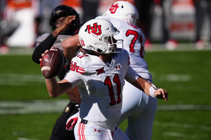 Nov 16, 2024; Boulder, Colorado, USA; Utah Utes quarterback Isaac Wilson (11) prepares to pass the ball in the second quarter against the Colorado Buffaloes at Folsom Field. Mandatory Credit: Ron Chenoy-Imagn Images