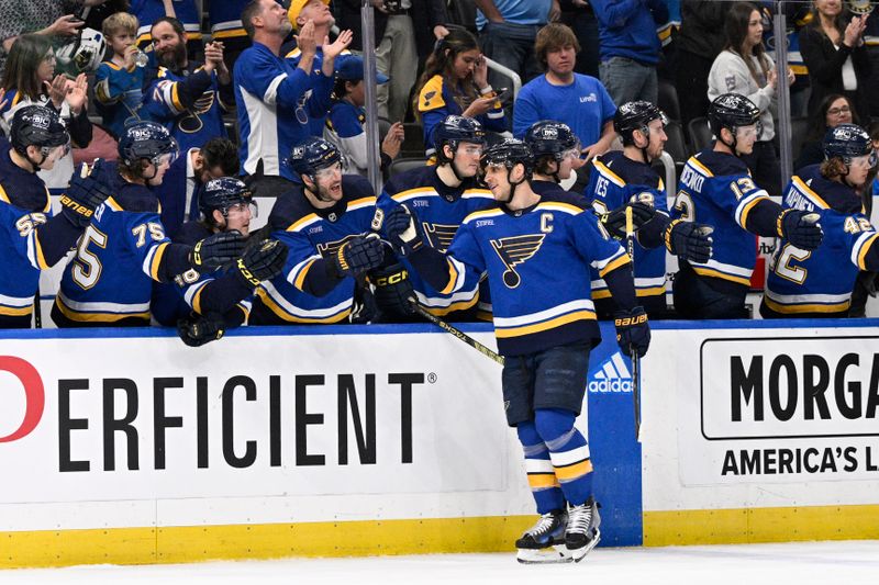 Apr 14, 2024; St. Louis, Missouri, USA; s20 is congratulated by teammates after scoring a goal against the Seattle Kraken during the third period at Enterprise Center. Mandatory Credit: Jeff Le-USA TODAY Sports