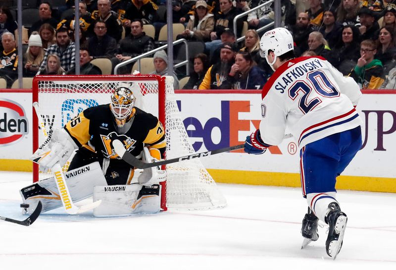 Jan 27, 2024; Pittsburgh, Pennsylvania, USA;  Montreal Canadiens left wing Juraj Slafkovsky (20) scores a power play goal against Pittsburgh Penguins goaltender Tristan Jarry (35) during the second period at PPG Paints Arena. Mandatory Credit: Charles LeClaire-USA TODAY Sports