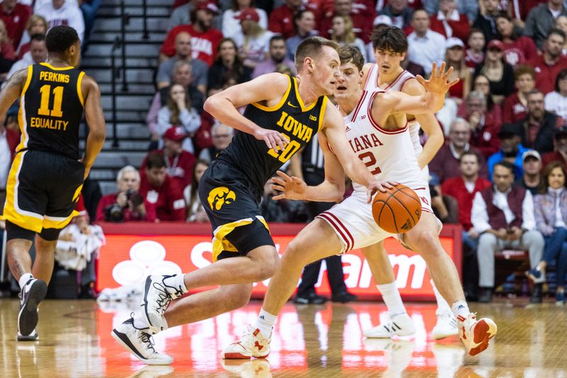 Feb 28, 2023; Bloomington, Indiana, USA; Iowa Hawkeyes forward Payton Sandfort (20) dribbles the ball while Indiana Hoosiers forward Miller Kopp (12) defends in the first half at Simon Skjodt Assembly Hall. Mandatory Credit: Trevor Ruszkowski-USA TODAY Sports