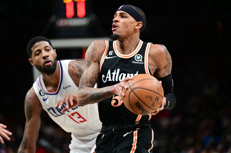 ATLANTA, GA - JANUARY 28: Dejounte Murray #5 of the Atlanta Hawks drives to the basket during the game on January 28, 2023 at State Farm Arena in Atlanta, Georgia.  NOTE TO USER: User expressly acknowledges and agrees that, by downloading and/or using this Photograph, user is consenting to the terms and conditions of the Getty Images License Agreement. Mandatory Copyright Notice: Copyright 2023 NBAE (Photo by Adam Hagy/NBAE via Getty Images)