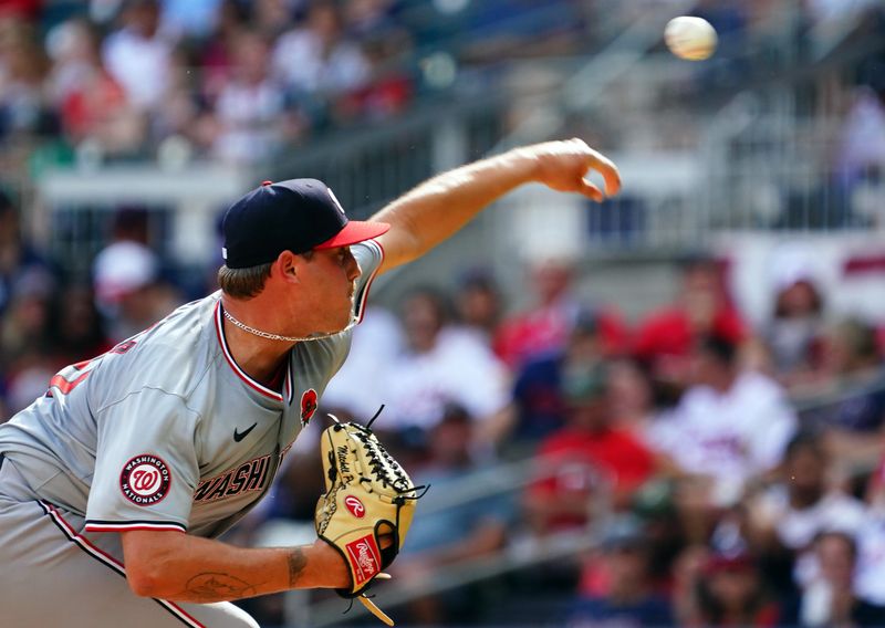 May 27, 2024; Cumberland, Georgia, USA; Washington Nationals pitcher Mitchell Parker (70) fires off a pitch against the Atlanta Braves during the third inning at Truist Park. Mandatory Credit: John David Mercer-USA TODAY Sports