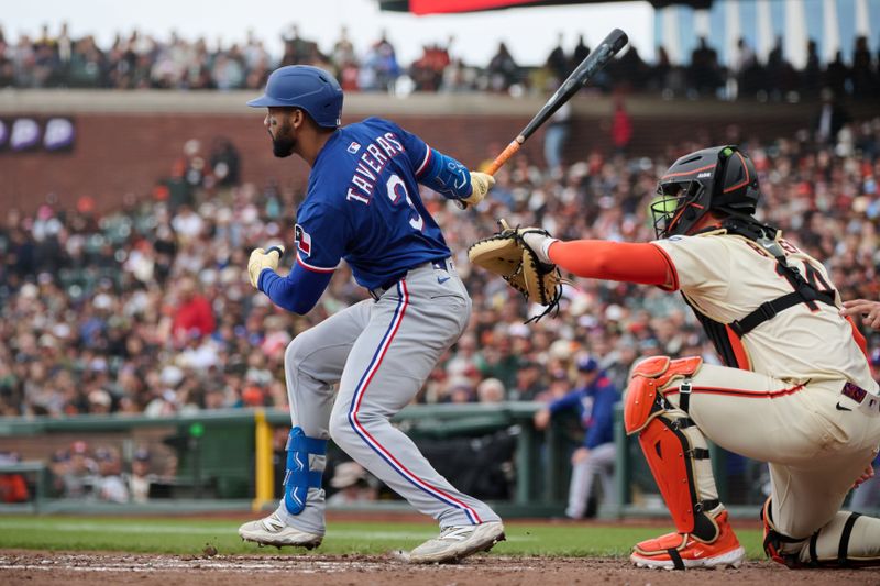 Apr 27, 2025; San Francisco, California, USA; Texas Rangers outfielder Leody Taveras (3) hits a double against San Francisco Giants catcher Patrick Bailey (14) during the seventh inning at Oracle Park. Mandatory Credit: Robert Edwards-Imagn Images