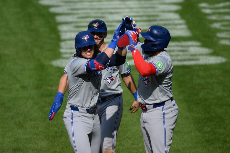 Jul 29, 2024; Baltimore, Maryland, USA; Toronto Blue Jays outfielder Addison Barger (47) celebrates with second baseman Spencer Horwitz (48) and first baseman Vladimir Guerrero Jr. (27) after hitting a home run against the Baltimore Orioles during the fifth inning at Oriole Park at Camden Yards. Mandatory Credit: Reggie Hildred-USA TODAY Sports