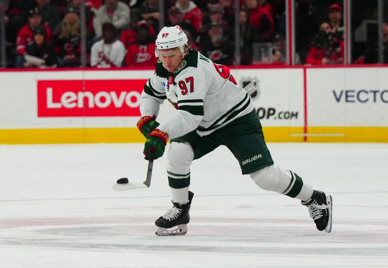 Jan 21, 2024; Raleigh, North Carolina, USA;  Minnesota Wild left wing Kirill Kaprizov (97) skates with the puck against the Carolina Hurricanes during the second period at PNC Arena. Mandatory Credit: James Guillory-USA TODAY Sports