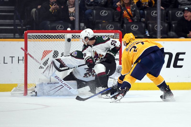 Feb 10, 2024; Nashville, Tennessee, USA; Nashville Predators defenseman Ryan McDonagh (27) scores the game-winning goal against Arizona Coyotes goaltender Connor Ingram (39) in overtime at Bridgestone Arena. Mandatory Credit: Christopher Hanewinckel-USA TODAY Sports