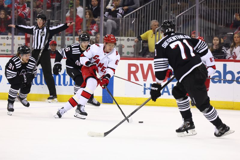 Mar 9, 2024; Newark, New Jersey, USA; Carolina Hurricanes center Evgeny Kuznetsov (92) skates with the puck against the New Jersey Devils during the third period at Prudential Center. Mandatory Credit: Ed Mulholland-USA TODAY Sports