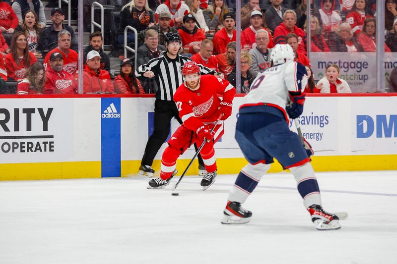 Mar 19, 2024; Detroit, Michigan, USA; Detroit Red Wings center Michael Rasmussen (27) handles the puck during the third period of the game against the Columbus Blue Jackets at Little Caesars Arena. Mandatory Credit: Brian Bradshaw Sevald-USA TODAY Sports