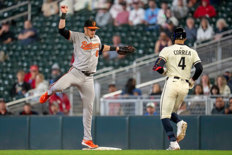 May 7, 2025; Minneapolis, Minnesota, USA; Baltimore Orioles first baseman Ryan Mountcastle (6) forces out Minnesota Twins shortstop Carlos Correa (4) at first base after catching a high throw in the eighth inning at Target Field. Mandatory Credit: Jesse Johnson-Imagn Images