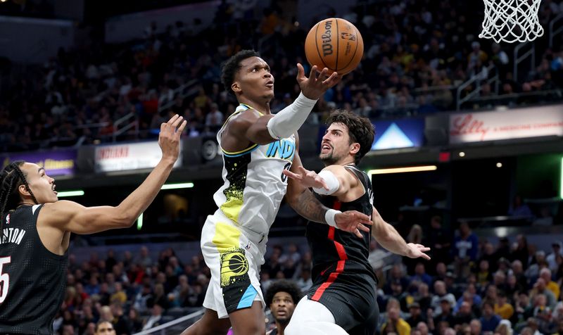 INDIANAPOLIS, INDIANA - NOVEMBER 27: Bennedict Mathurin #00 of the Indiana Pacers shoots the ball while defended by Deni Avdija #8 of the Portland Trailblazers at Gainbridge Fieldhouse on November 27, 2024 in Indianapolis, Indiana.<p><br/></p>NOTE TO USER: User expressly acknowledges and agrees that, by downloading and or using this photograph, User is consenting to the terms and conditions of the Getty Images License Agreement. (Photo by Andy Lyons/Getty Images)