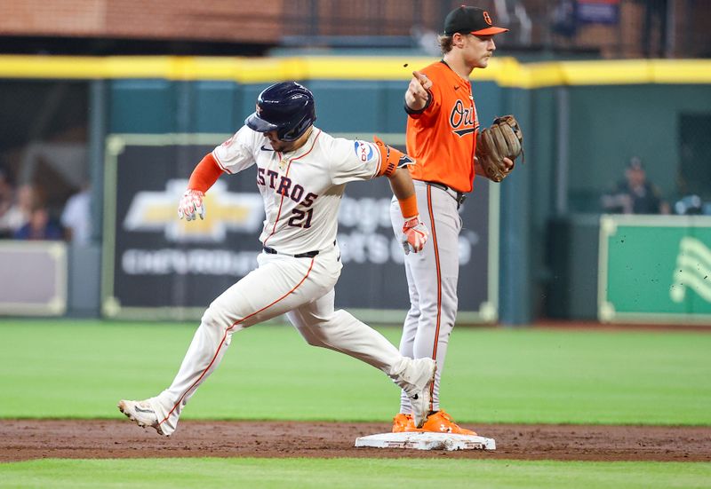 Jun 22, 2024; Houston, Texas, USA; Baltimore Orioles shortstop Gunnar Henderson (2) motsions as Houston Astros catcher Yainer Diaz (21) heads to third base on a triple during the second inning at Minute Maid Park. Mandatory Credit: Troy Taormina-USA TODAY Sports