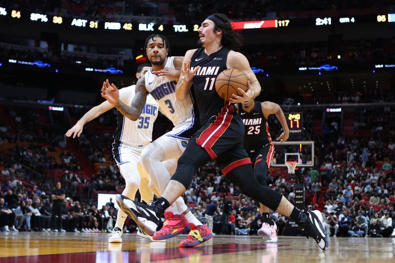 MIAMI, FLORIDA - FEBRUARY 06: Jaime Jaquez Jr. #11 of the Miami Heat drives against Chuma Okeke #3 of the Orlando Magic during the fourth quarter of the game at Kaseya Center on February 06, 2024 in Miami, Florida. NOTE TO USER: User expressly acknowledges and agrees that, by downloading and or using this photograph, User is consenting to the terms and conditions of the Getty Images License Agreement. (Photo by Megan Briggs/Getty Images)