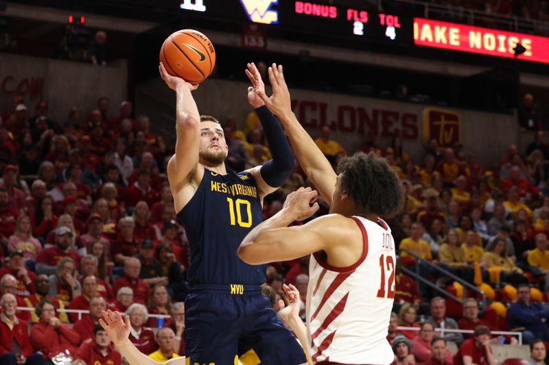 Feb 27, 2023; Ames, Iowa, USA; West Virginia Mountaineers guard Erik Stevenson (10) shoots over Iowa State Cyclones forward Robert Jones (12) during the first half at James H. Hilton Coliseum. Mandatory Credit: Reese Strickland-USA TODAY Sports