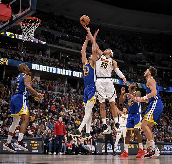 DENVER, CO - DECEMBER 25: Dario Saric (20) of the Golden State Warriors bodies Aaron Gordon (50) of the Denver Nuggets out of the way as they fight for a rebound during the fourth quarter of the Nuggets' 120-114 win at Ball Arena in Denver on Monday, December 25, 2023. (Photo by AAron Ontiveroz/The Denver Post)