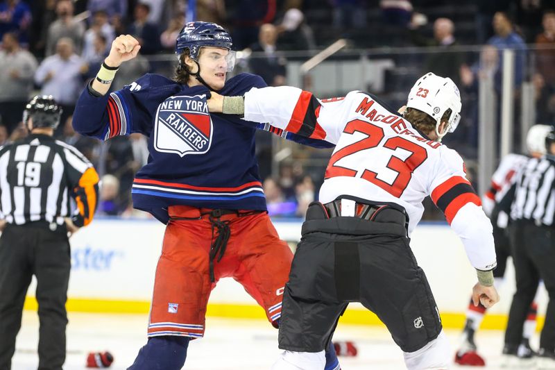 Apr 3, 2024; New York, New York, USA; New York Rangers center Matt Rempe (73) and New Jersey Devils defenseman Kurtis MacDermid (23) fight at start of the 1st period at Madison Square Garden. Mandatory Credit: Wendell Cruz-USA TODAY Sports