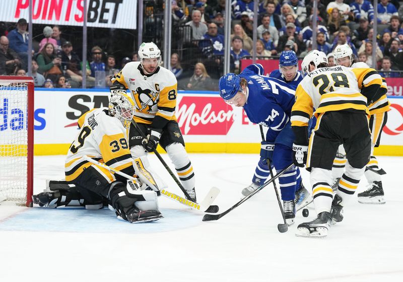 Apr 8, 2024; Toronto, Ontario, CAN; Toronto Maple Leafs center Bobby McMann (74) battles with Pittsburgh Penguins defenseman Marcus Pettersson (28) in front of goaltender Alex Nedeljkovic (39) during the first period at Scotiabank Arena. Mandatory Credit: Nick Turchiaro-USA TODAY Sports