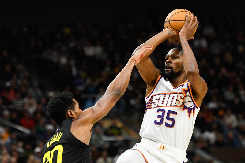 SALT LAKE CITY, UTAH - NOVEMBER 19: Kevin Durant #35 of the Phoenix Suns shoots the ball against Ochai Agbaji #30 of the Utah Jazz during the second half of a game at Delta Center on November 19, 2023 in Salt Lake City, Utah. NOTE TO USER: User expressly acknowledges and agrees that, by downloading and or using this photograph, User is consenting to the terms and conditions of the Getty Images License Agreement. (Photo by Alex Goodlett/Getty Images)