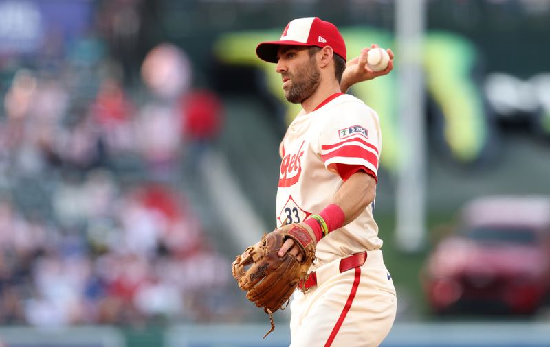 Jun 6, 2025; Anaheim, California, USA; Los Angeles Angels outfielder Chris Taylor (33) throws to first for an out during the second inning against the Seattle Mariners at Angel Stadium. Mandatory Credit: Jason Parkhurst-Imagn Images