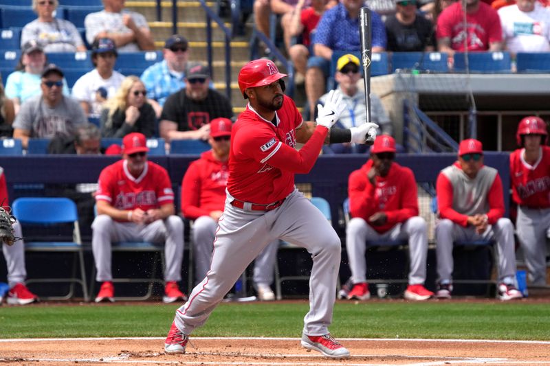 Mar 18, 2024; Phoenix, Arizona, USA; Los Angeles Angels center fielder Aaron Hicks (12) hits against the Milwaukee Brewers in the first inning at American Family Fields of Phoenix. Mandatory Credit: Rick Scuteri-USA TODAY Sports