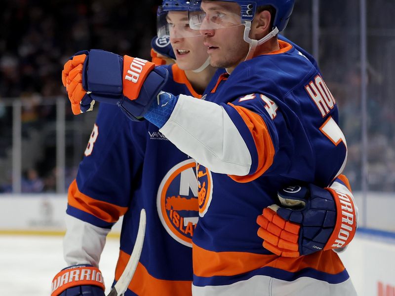 Dec 2, 2025; Elmont, New York, USA; New York Islanders center Bo Horvat (14) celebrates his goal against the Tampa Bay Lightning with defenseman Matthew Schaefer (48) during the second period at UBS Arena. Mandatory Credit: Brad Penner-Imagn Images
