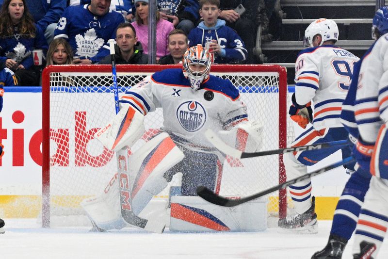 Nov 16, 2024; Toronto, Ontario, CAN;  Edmonton Oilers goalie Stuart Skinner (74) makes a save against the Toronto Maple Leafs in the first period at Scotiabank Arena. Mandatory Credit: Dan Hamilton-Imagn Images