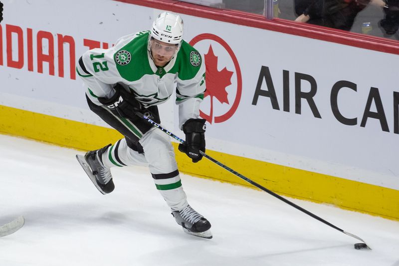 Feb 22, 2024; Ottawa, Ontario, CAN; Dallas Stars center Radek Faksa (12) skates with the puck in the third period against the  Ottawa Senators at the Canadian Tire Centre. Mandatory Credit: Marc DesRosiers-USA TODAY Sports