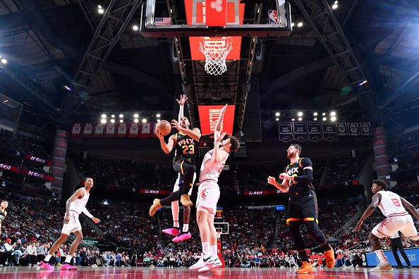 HOUSTON, TX - DECEMBER 27:   Eric Gordon #23 of the Phoenix Suns drives to the basket during the game against the Houston Rockets on December 27, 2023 at the Toyota Center in Houston, Texas. NOTE TO USER: User expressly acknowledges and agrees that, by downloading and or using this photograph, User is consenting to the terms and conditions of the Getty Images License Agreement. Mandatory Copyright Notice: Copyright 2023 NBAE (Photo by Logan Riely/NBAE via Getty Images)