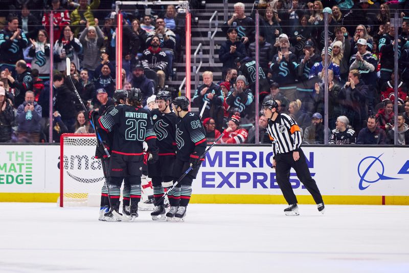 Jan 25, 2026; Seattle, Washington, USA; The Seattle Kraken celebrate a goal scored by Seattle Kraken defenseman Ryker Evans (41) during the second period against the New Jersey Devils at Climate Pledge Arena. Mandatory Credit: Blake Dahlin-Imagn Images