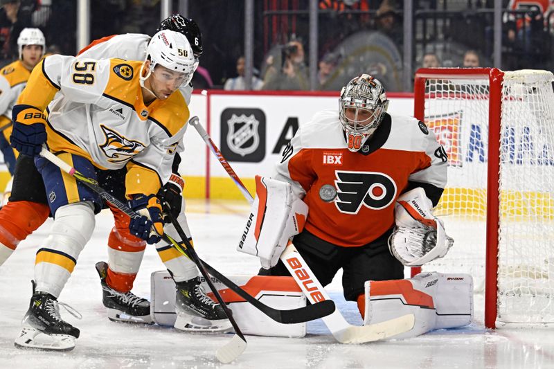 Oct 30, 2025; Philadelphia, Pennsylvania, USA; Philadelphia Flyers goaltender Dan Vladar (80) makes a save as Nashville Predators left wing Michael Bunting (58) looks on during the second period at Xfinity Mobile Arena. Mandatory Credit: Eric Hartline-Imagn Images
