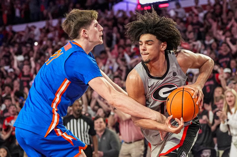 Feb 25, 2025; Athens, Georgia, USA; Georgia Bulldogs forward Asa Newell (14) gets fouled by Florida Gators forward Alex Condon (21) late in the game during the second half at Stegeman Coliseum. Mandatory Credit: Dale Zanine-Imagn Images