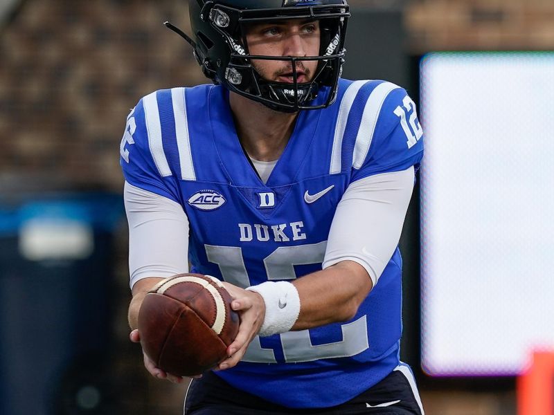 Nov 7, 2020; Durham, North Carolina, USA; Duke Blue Devils quarterback Gunnar Holmberg (12) hands off against the North Carolina Tar Heels during the second half at Wallace Wade Stadium. Mandatory Credit: Jim Dedmon-USA TODAY Sports