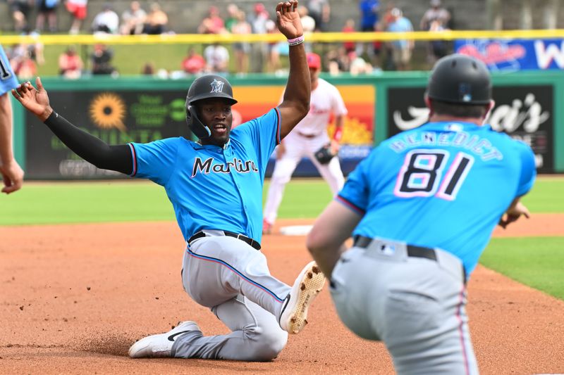 Mar 1, 2024; Clearwater, Florida, USA; Miami Marlins right fielder Jesus Sanchez (12) slides into third base in the first inning of the spring training game against the Philadelphia Phillies at BayCare Ballpark. Mandatory Credit: Jonathan Dyer-USA TODAY Sports