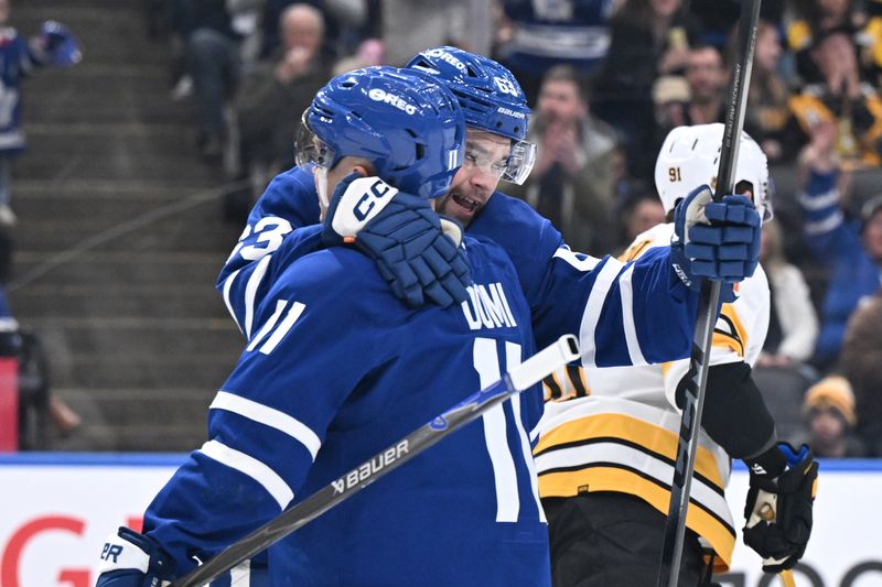 Nov 8, 2025; Toronto, Ontario, CAN;  Toronto Maple Leafs forward Matias Macelli (63) celebrates with forward Max Domi (11) after scoring a goal against the Boston Bruins in the first period at Scotiabank Arena. Mandatory Credit: Dan Hamilton-Imagn Images