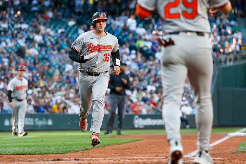 Jul 3, 2024; Seattle, Washington, USA; Baltimore Orioles catcher Adley Rutschman (35) scores a run against the Seattle Mariners during the third inning at T-Mobile Park. Mandatory Credit: Joe Nicholson-USA TODAY Sports