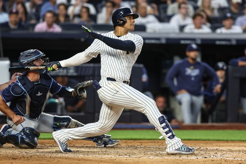 Jul 19, 2024; Bronx, New York, USA;  New York Yankees right fielder Juan Soto (22) hits a double in the fourth inning against the Tampa Bay Rays at Yankee Stadium. Mandatory Credit: Wendell Cruz-USA TODAY Sports