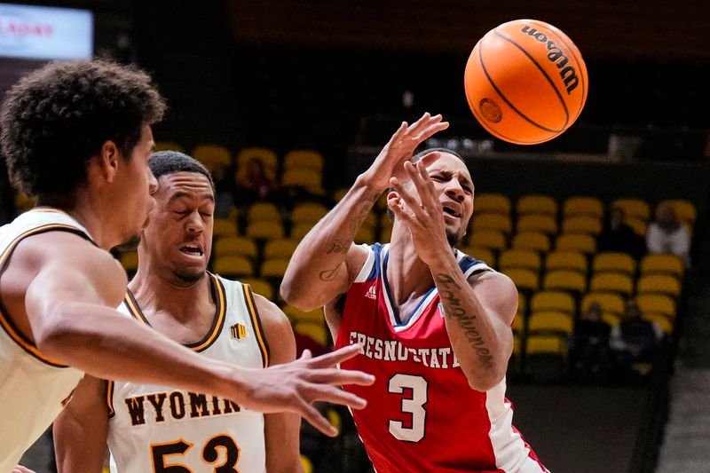 Jan 31, 2023; Laramie, Wyoming, USA; Fresno State Bulldogs guard Isaiah Hill (3) is fouled by Wyoming Cowboys guard Xavier DuSell (53) during the second half at Arena-Auditorium. Mandatory Credit: Troy Babbitt-USA TODAY Sports