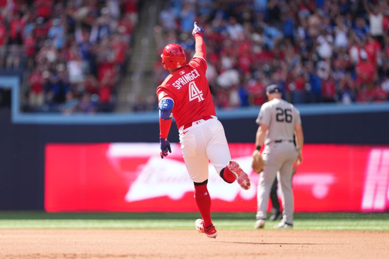 Jul 1, 2025; Toronto, Ontario, CAN; Toronto Blue Jays right fielder George Springer (4) runs the bases after hitting a home run against the New York Yankees during the fourth inning at Rogers Centre. Mandatory Credit: Nick Turchiaro-Imagn Images