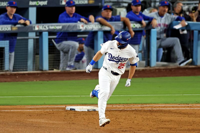 Oct 20, 2024; Los Angeles, California, USA; Los Angeles Dodgers outfielder Tommy Edman (25) celebrates after hitting a two run home run during the third inning against the New York Mets during game six of the NLCS for the 2024 MLB playoffs at Dodger Stadium. Mandatory Credit: Jason Parkhurst-Imagn Images
