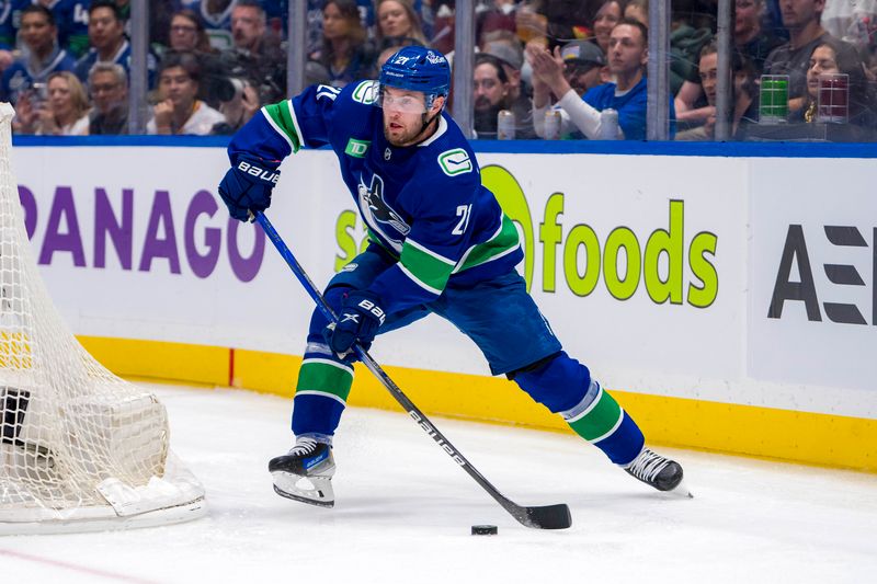 May 16, 2024; Vancouver, British Columbia, CAN; Vancouver Canucks forward Nils Hoglander (21) makes a pass against the Edmonton Oilers during the third period in game five of the second round of the 2024 Stanley Cup Playoffs at Rogers Arena. Mandatory Credit: Bob Frid-USA TODAY Sports