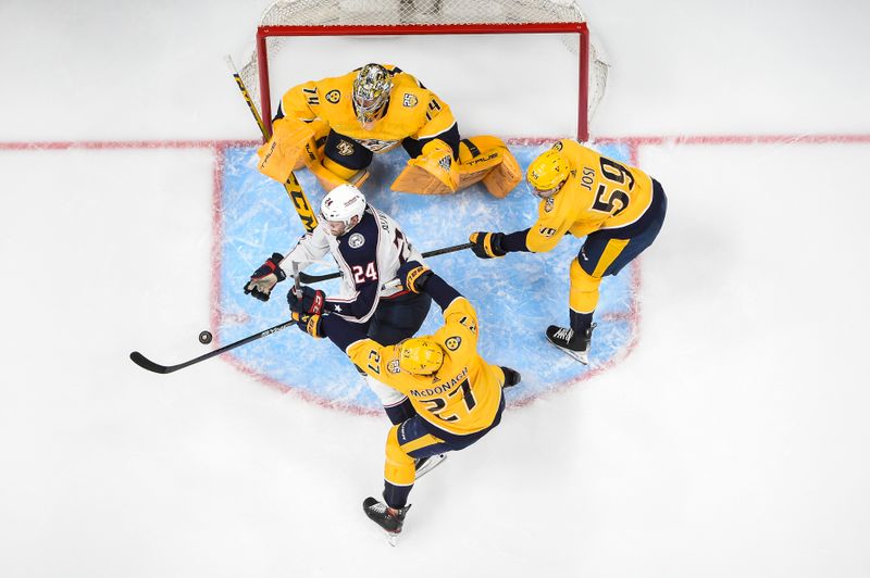 Apr 13, 2024; Nashville, Tennessee, USA; Nashville Predators goaltender Juuse Saros (74) blocks the shot of Columbus Blue Jackets right wing Mathieu Olivier (24) during the first period at Bridgestone Arena. Mandatory Credit: Steve Roberts-USA TODAY Sports