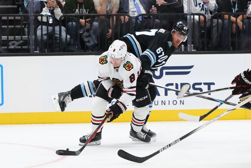 Oct 8, 2024; Salt Lake City, Utah, USA; Chicago Blackhawks center Ryan Donato (8) and Utah Hockey Club forward Lawson Crouse (67) battle for the puck during the third period at Delta Center. Mandatory Credit: Rob Gray-Imagn Images