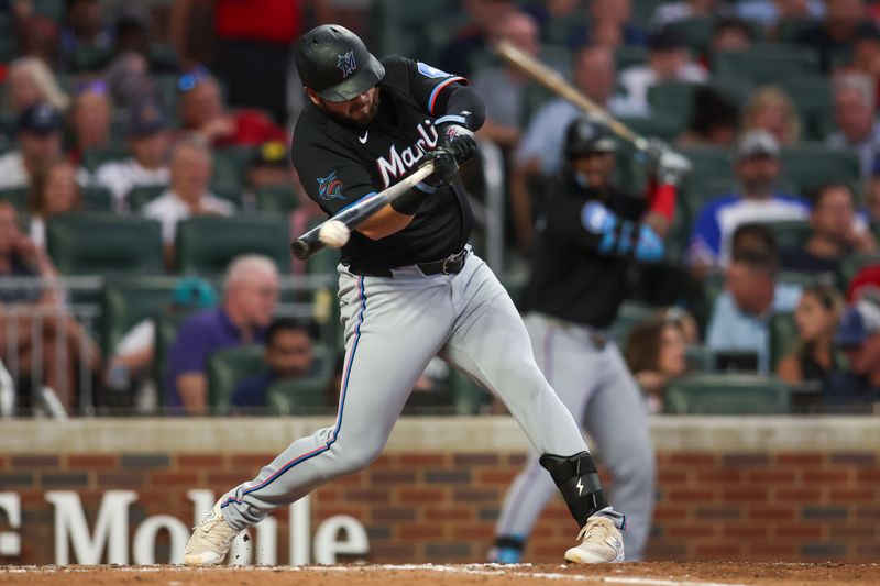 Aug 3, 2024; Atlanta, Georgia, USA; Miami Marlins first baseman Jake Burger (36) hits a RBI single against the Atlanta Braves in the fifth inning at Truist Park. Mandatory Credit: Brett Davis-USA TODAY Sports