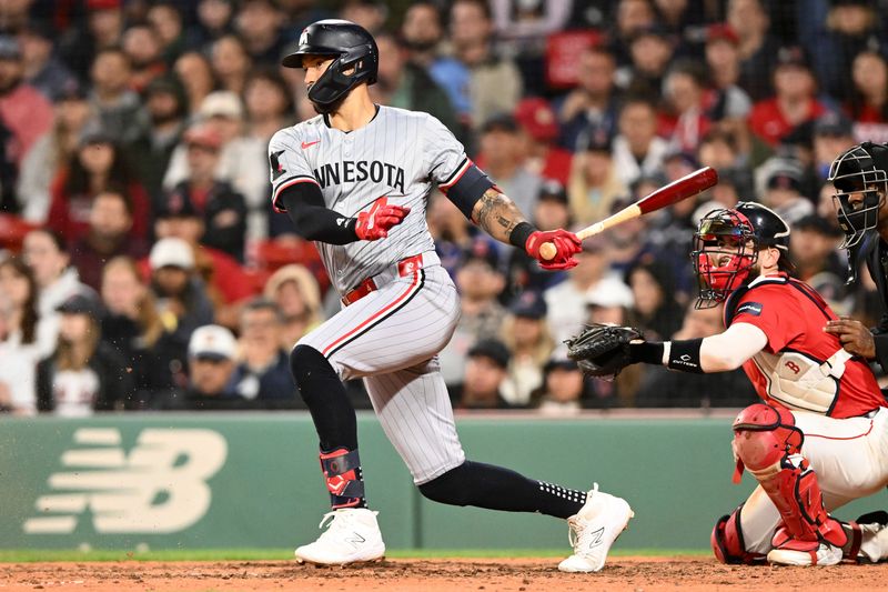 Sep 20, 2024; Boston, Massachusetts, USA; Minnesota Twins shortstop Carlos Correa (4) hits a RBI against the Boston Red Sox during the seventh inning at Fenway Park. Mandatory Credit: Brian Fluharty-Imagn Images